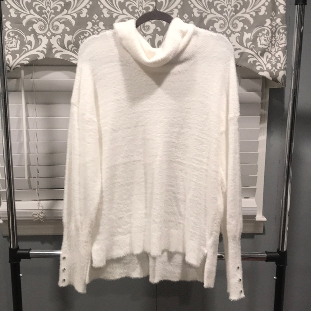 White turtleneck sweater with silver buttons